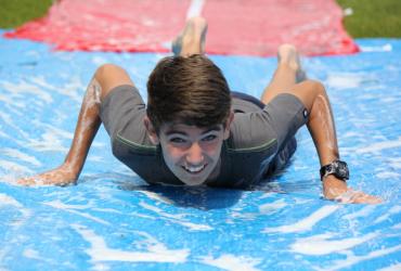 boy on water slide xuk summer camp
