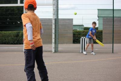 Boys playing cricket at UK Day Camp