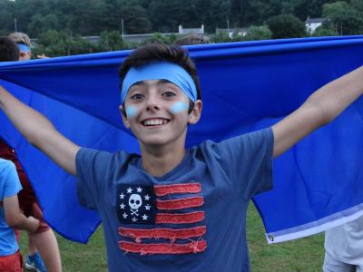 camper representing blue team in colour war at english summer activity camp