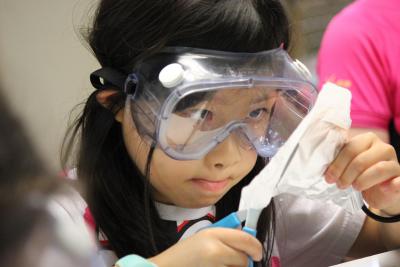chinese girl in science activity at best summer camp in england