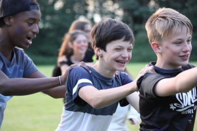 teenagers laughing at summer camp with friends in england