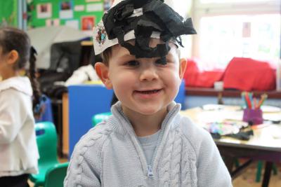 Boy in blue jumper wearing a handmade pirate hat