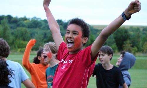 Children smiling while celebrating at XUK Summer Camp