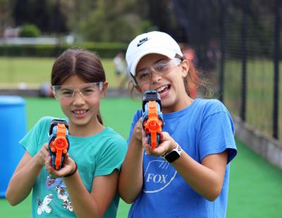 Two children holding nerf guns at xuk summer camp