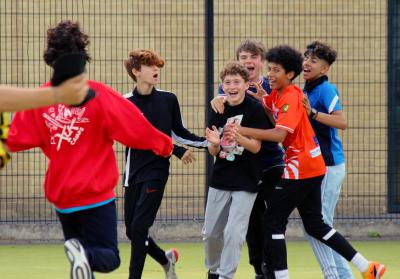 Group of teenage boys celebrating at summer camp