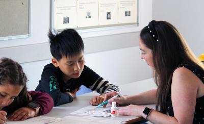 two students and their English teacher in class at xuk english school