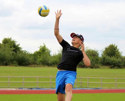 Teenage boy playing volleyball at XUK summer camp