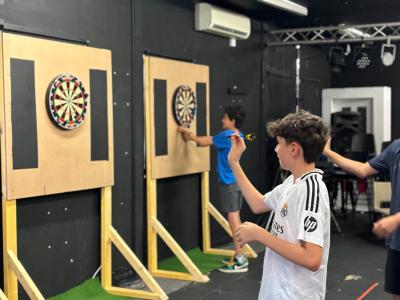 teenage boys playing darts at XUK Summer camp