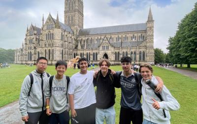 group of teenage boys in front of Salisbury Cathedral while on a trip with XUK Camps