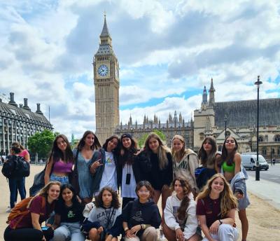 group of teenage girls standing in front of Big Ben while on a trip with XUK Summer Camp