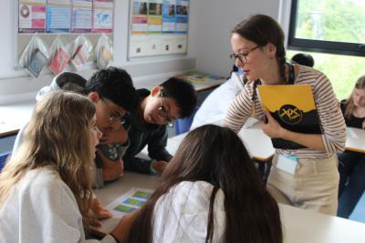 XUK staff member teaching English lesson to group of teens