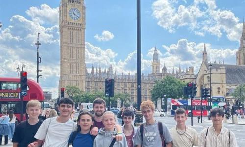 Group of teenage boys in front of Big Ben on trip with english summer school